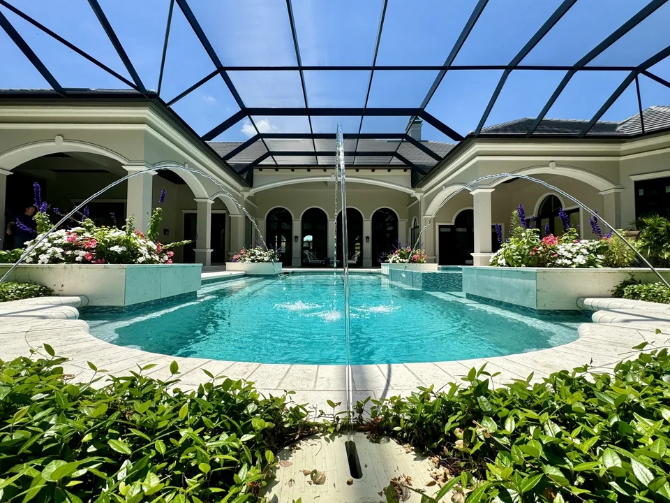 Screen enclosure roof framing above the Naples courtyard pool