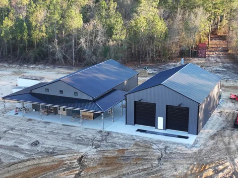 Aerial view of a metal building complex with a covered breezeway