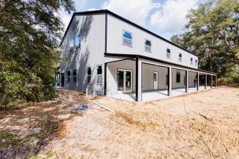 Two-story metal building with a full-length covered porch