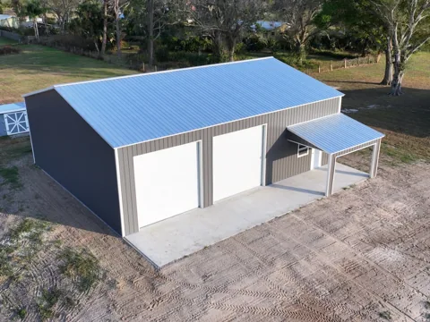 Steel building with two overhead doors and a covered entry